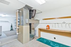 a kitchen with a refrigerator in the middle of a room at Schweitzer Ullr Retreat in Sandpoint +50 photos