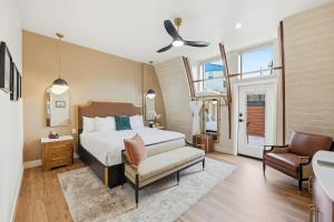 a bedroom with a bed and a chair and a window at The Q Inn in Morro Bay