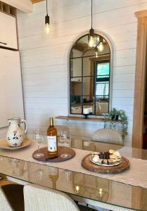 a table with two glasses and a bottle of wine at Holiday house Flores near Kolasin in Kolašin
