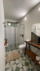 a bathroom with a toilet and a glass shower at Hotel Casa Dulces del Jardín in Jardin