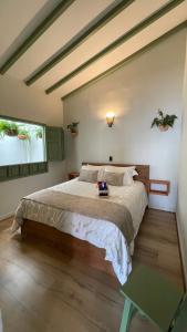 a bedroom with a large bed and two windows at Hotel Casa Dulces del Jardín in Jardin