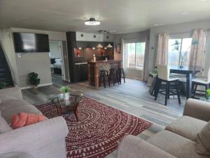 a living room with a couch and a table at Lakefront Retreat, Pool, Hottub, Firepit in Azle