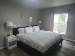 a bedroom with a bed and a window at Lakefront Retreat, Pool, Hottub, Firepit in Azle +30 photos