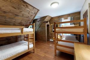 a room with two bunk beds and a table at The Mitchell House in North Woodstock