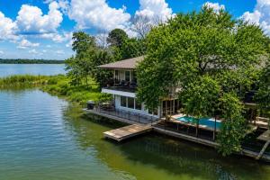 an image of a house on the water at Lakefront Retreat, Pool, Hottub, Firepit in Azle