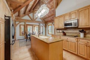 a large kitchen with wooden cabinets and a kitchen island at Freedom in Freedom