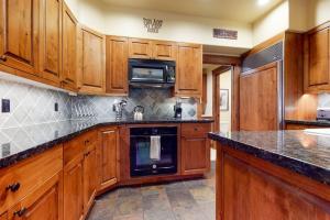 a kitchen with wooden cabinets and a black appliance at 535 Snow King Loop in Jackson