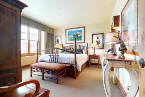 a bedroom with a bed and a chair and a table at 535 Snow King Loop in Jackson