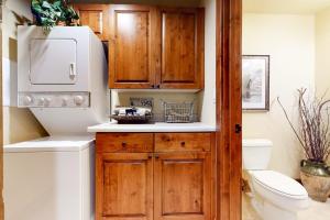 a bathroom with a toilet and a wooden cabinet at 535 Snow King Loop in Jackson +65 photos