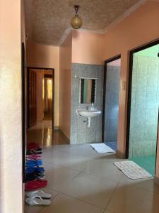 a bathroom with a sink and a shower and a mirror at Barizi Cottage in Tulu +13 photos