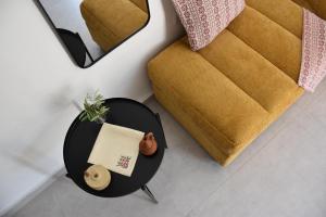 a table with a napkin on it next to a couch at Stone Suites in Famagusta