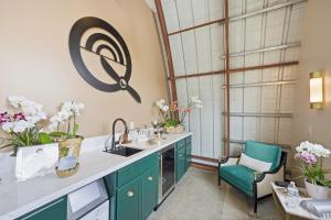 a kitchen with green cabinets and a sink at The Q Inn in Morro Bay
