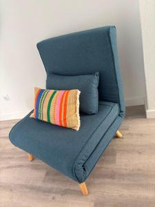 a blue couch with a colorful pillow on it at Blessed House in Portimão +41 photos