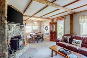 a living room with a couch and a fireplace at Town Farm Retreat in Ludlow
