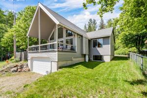 a house with a large yard in front of it at Garfield Bay View Home in Sagle