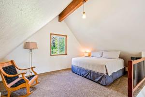 a bedroom with a bed and a chair at Garfield Bay View Home in Sagle