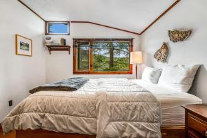 a bedroom with a large bed and a window at Beebe Lake House in Castleton