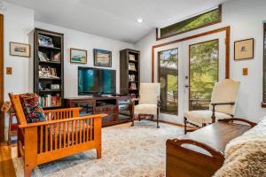 a living room with a couch and a tv at Beebe Lake House in Castleton