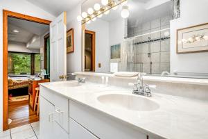 a bathroom with two sinks and a large mirror at Beebe Lake House in Castleton +82 photos