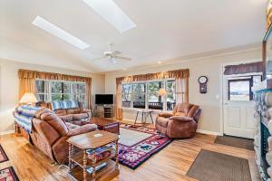 a living room with two couches and a table at The Wild Rose in Sagle