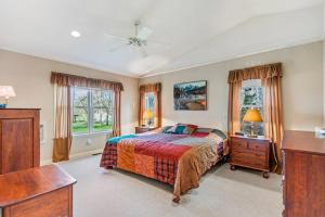 a bedroom with a bed and a dresser and two windows at The Wild Rose in Sagle