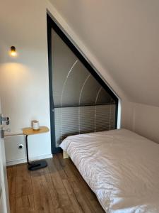 a bedroom with a large bed and a window at Stodoła Parysa in Wola Korytnicka