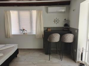 a room with two chairs and a desk in a room at Studios Ciao Bella city centre with free parking in Šibenik +11 photos