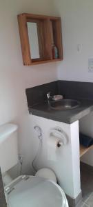 a bathroom with a toilet and a sink at cabañas UMA RAYMI in Juella +23 photos