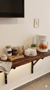 a table with cups and dishes on a counter at La Toscana Hostel in Villa de Leyva