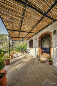 an outdoor patio with a wooden roof with a table and chairs at blue moon in Chefchaouen