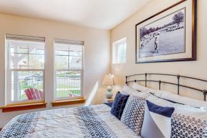 a bedroom with a bed and two windows at Dover Delight in Dover