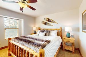 a bedroom with a bed and a ceiling fan at Whiplash in Sandpoint