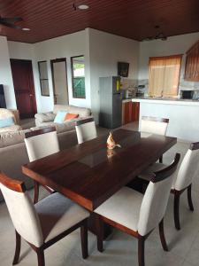 a dining room with a wooden table and chairs at Altura & lago in San Nicolás