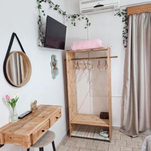 a room with a wooden desk and a mirror at Chrysanthi Melitsa apts. in Sidari