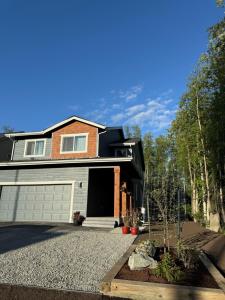 a house with a garage and a driveway at SINGLE HOUSE 1- Beautiful- Peaceful-4Beds 3baths- Sleeps 12 in Anchorage