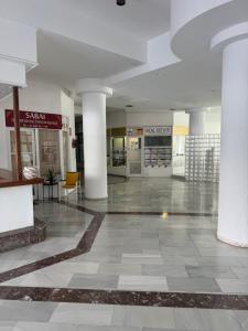 an empty lobby of a building with columns at La Estrella del Sur in Adeje +72 photos