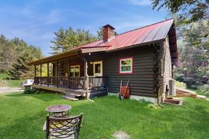 a small log cabin with a red roof at Easton Escape a notch above in Sugar Hill