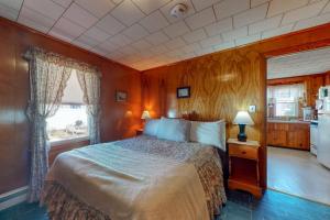 a bedroom with a large bed and a kitchen at Beach Bungalow in Seabrook