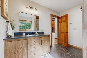 a bathroom with a sink and a mirror at The Lodge in Madison +39 photos