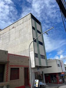 a building with a street light in front of it at Hotel Piracema in Caruaru