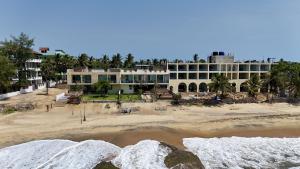 a large building on the beach with a beach at Hotel Beach Castle in Arugam Bay