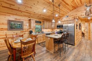 a kitchen and dining room with a table and chairs at Beside Still Water 2 in Cosby