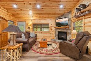 a living room with a couch and a fireplace at Beside Still Water 2 in Cosby