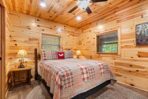 a bedroom with a bed in a log cabin at Beside Still Water 2 in Cosby