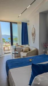 a hotel room with two beds and a living room at TreA Suites By Aria in Vlorë