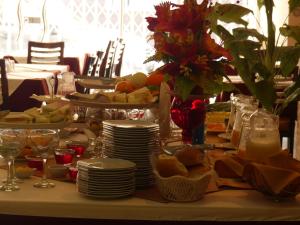 a table with plates of food on a table at Hotel San Martín in Tacna