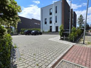 a parking lot with two cars parked in front of a building at ToTuLokum in Krakow