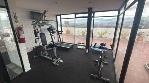 a gym with two treadmills and bikes in a building at Mumbai SkyLine Luxury Suite in Quito