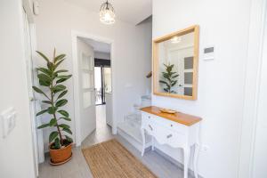a hallway with a vanity and a mirror and a plant at Casa flor del Rocio in La Rinconada