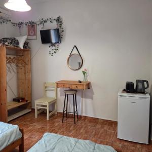 a room with a desk and a mirror and a bed at Chrysanthi Melitsa apts. in Sidari